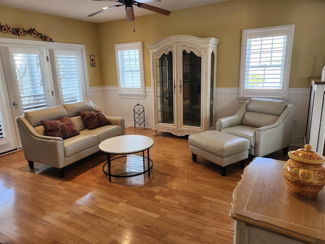 living room with light wood-type flooring and ceiling fan