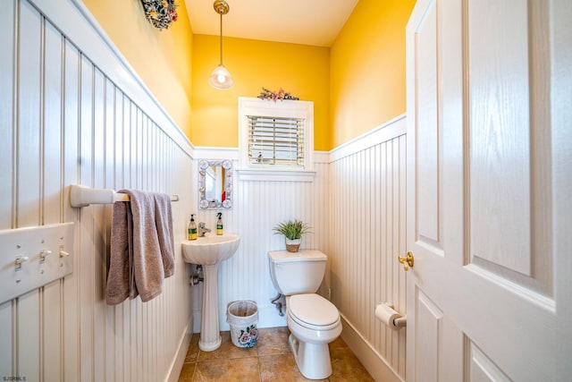 bathroom with toilet and tile patterned flooring