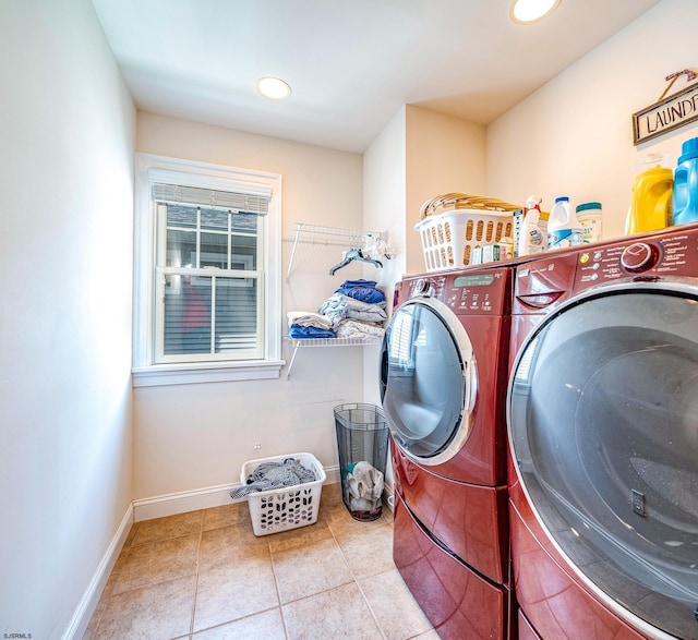 laundry room featuring washing machine and dryer and light tile patterned floors