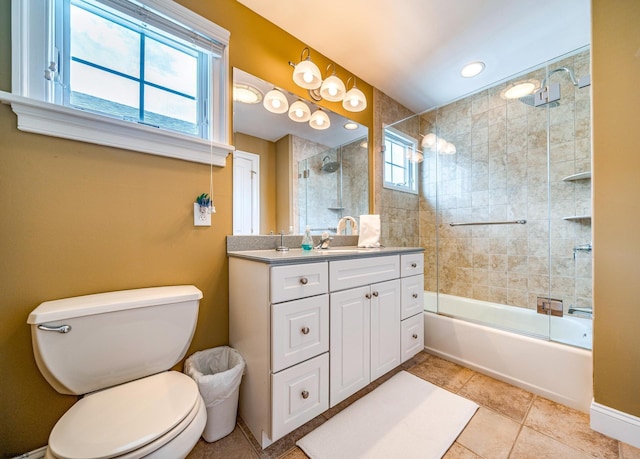 full bathroom with vanity, shower / bath combination with glass door, toilet, and a wealth of natural light