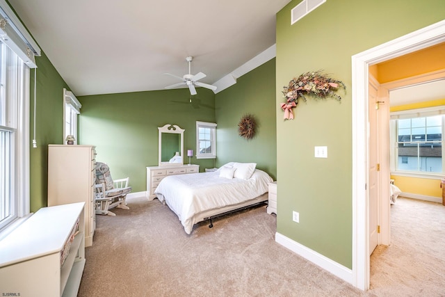 bedroom featuring ceiling fan, multiple windows, and light carpet