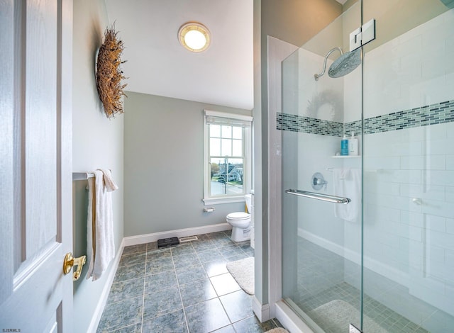 bathroom featuring toilet and walk in shower