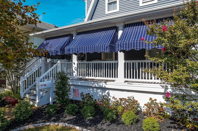 view of side of property with stairs