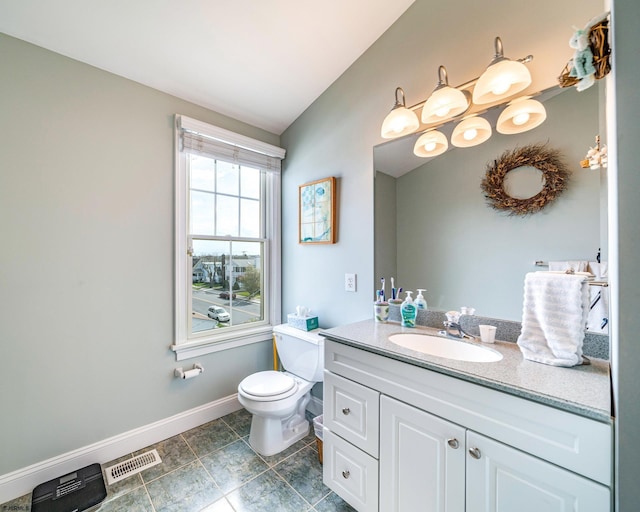 bathroom with lofted ceiling, vanity, and toilet