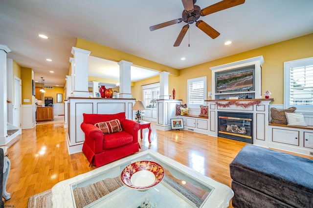 living room with ceiling fan, light hardwood / wood-style flooring, and a wealth of natural light