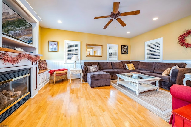 living room featuring ceiling fan and light hardwood / wood-style flooring