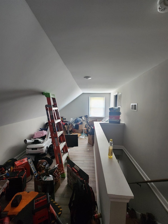 bonus room with lofted ceiling and wood-type flooring