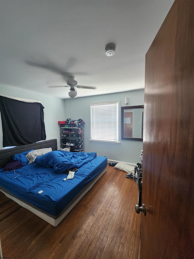 bedroom with wood-type flooring and ceiling fan