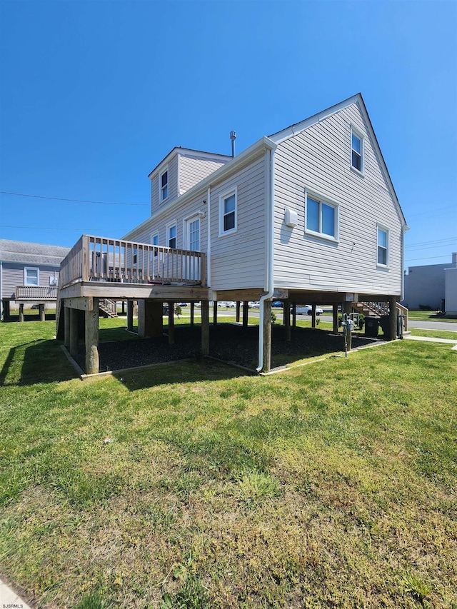 back of house with a lawn and a wooden deck