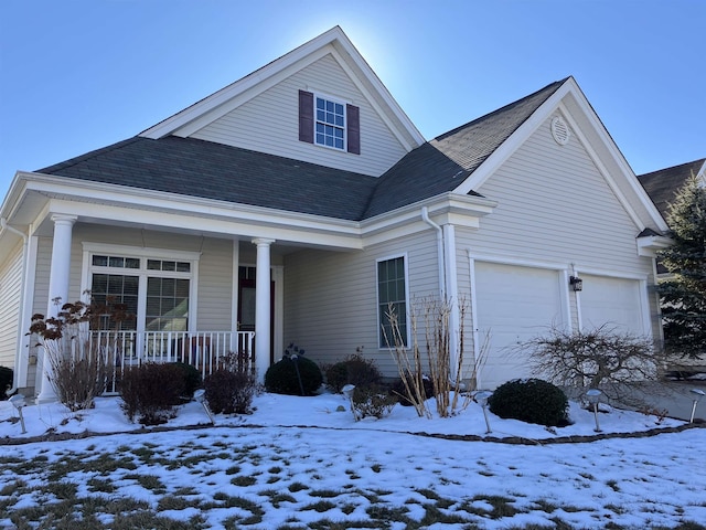 front of property with covered porch and a garage