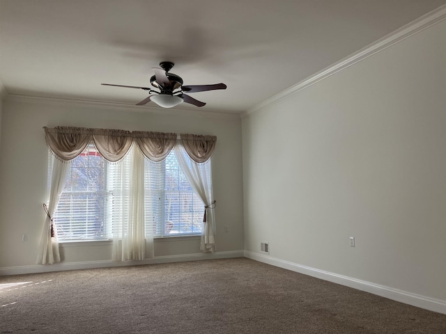 carpeted spare room featuring ornamental molding and ceiling fan