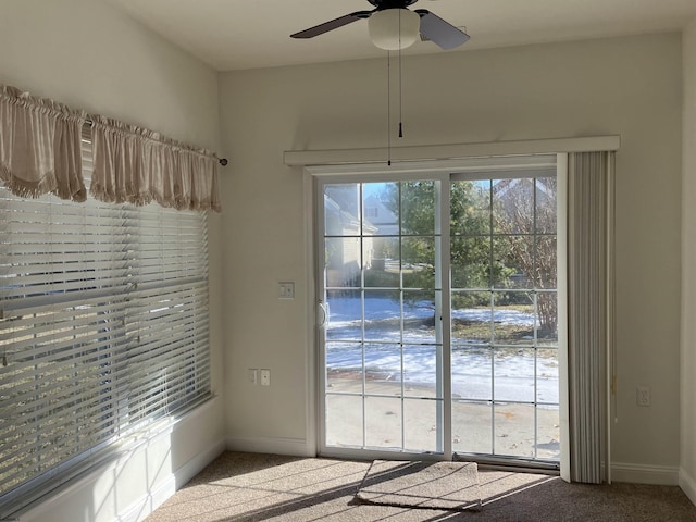 entryway featuring light colored carpet and ceiling fan