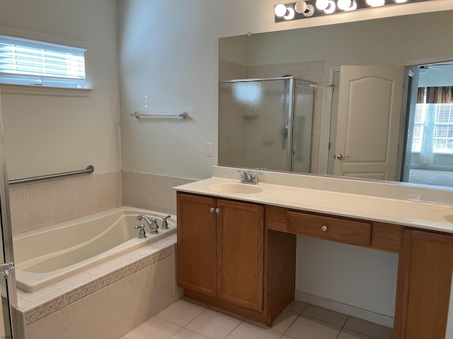 bathroom with tile patterned flooring, shower with separate bathtub, and vanity