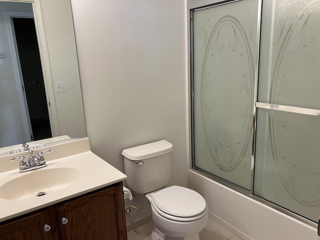 full bathroom with combined bath / shower with glass door, tile patterned floors, vanity, and toilet