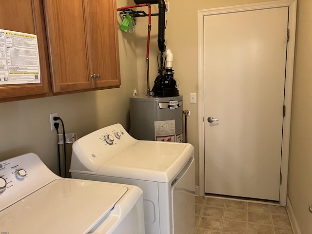 laundry room with gas water heater, washer and clothes dryer, and cabinets