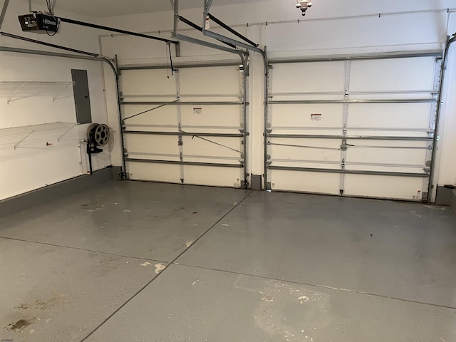 garage with electric panel and a garage door opener