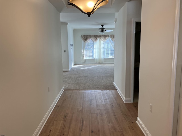 corridor featuring light colored carpet