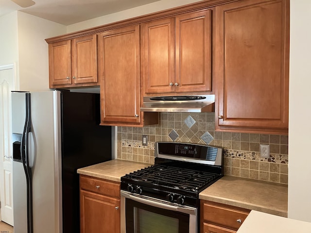 kitchen with stainless steel appliances and backsplash