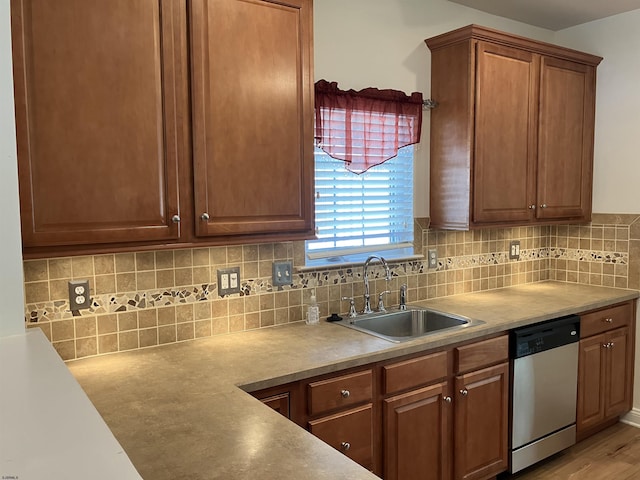 kitchen with sink, light wood-type flooring, dishwasher, and tasteful backsplash