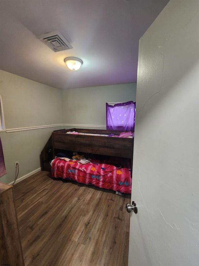 bedroom with wood-type flooring