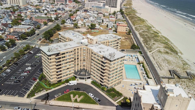 birds eye view of property featuring a water view and a view of the beach