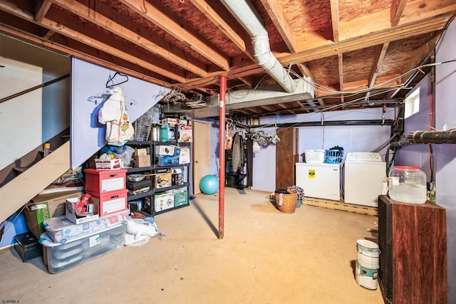 basement featuring fridge and washing machine and dryer