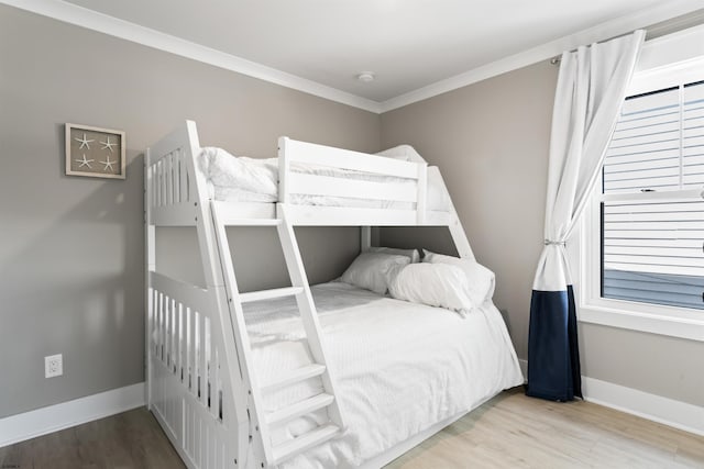 bedroom featuring light hardwood / wood-style floors and crown molding