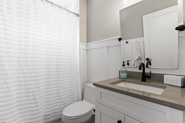 bathroom featuring walk in shower, vanity, and toilet