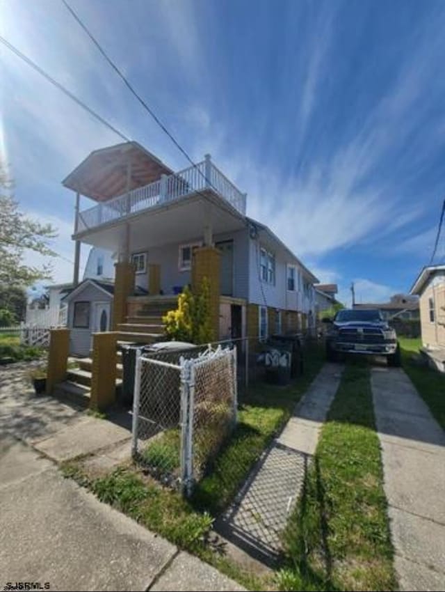 view of side of home featuring a balcony