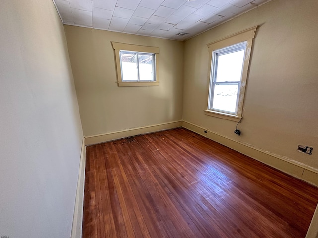 unfurnished room featuring a healthy amount of sunlight and hardwood / wood-style floors