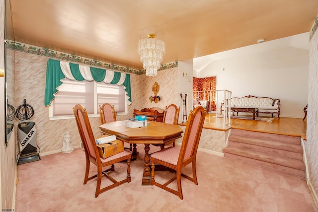 carpeted dining space featuring a notable chandelier