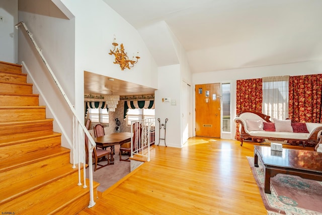 living room with hardwood / wood-style floors and vaulted ceiling