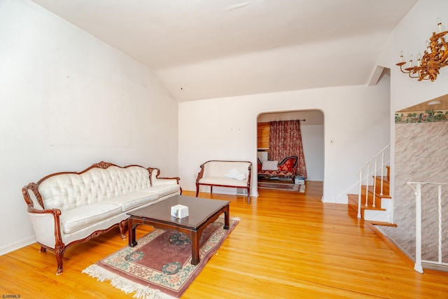 living room with wood-type flooring and vaulted ceiling