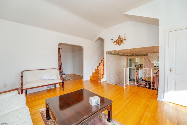 living room featuring hardwood / wood-style flooring and vaulted ceiling