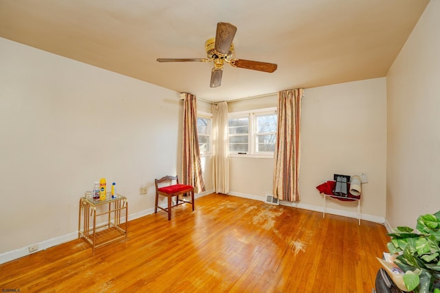 sitting room featuring ceiling fan and hardwood / wood-style flooring