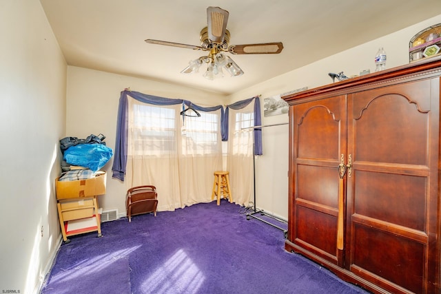 sitting room with dark colored carpet and ceiling fan