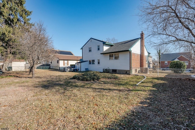 back of house with a lawn