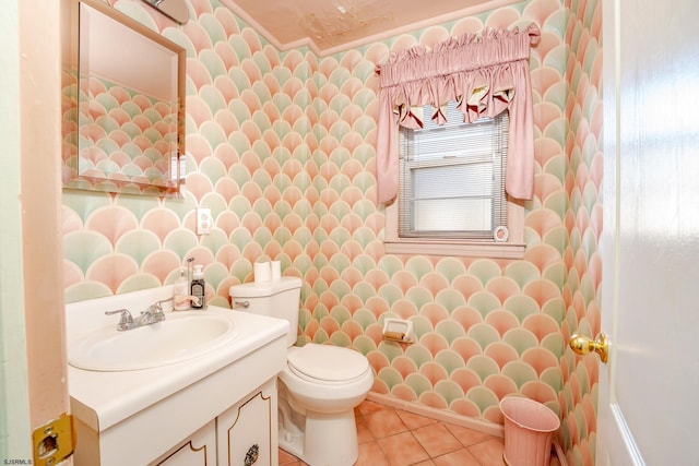 bathroom with toilet, vanity, and tile patterned floors