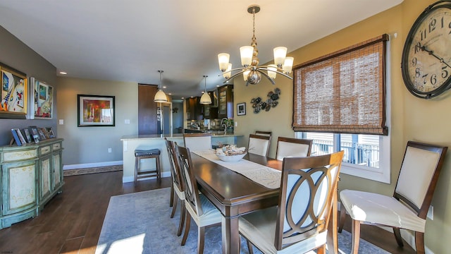 dining room with dark wood-type flooring and an inviting chandelier