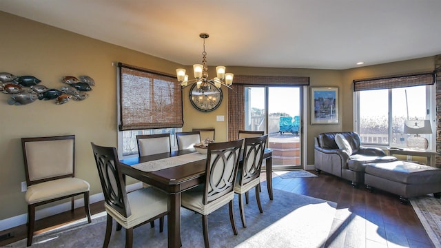 dining space with dark wood-type flooring and a chandelier