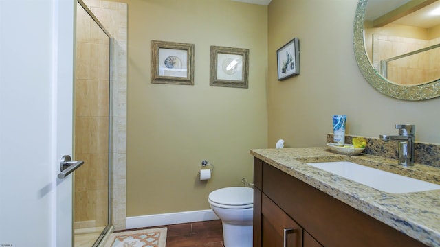 bathroom featuring toilet, walk in shower, and vanity