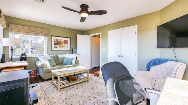 living room featuring ceiling fan and wood-type flooring