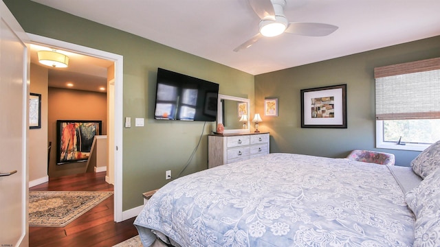 bedroom featuring ceiling fan and dark hardwood / wood-style floors