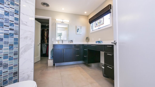 bathroom with toilet, tile patterned floors, and vanity