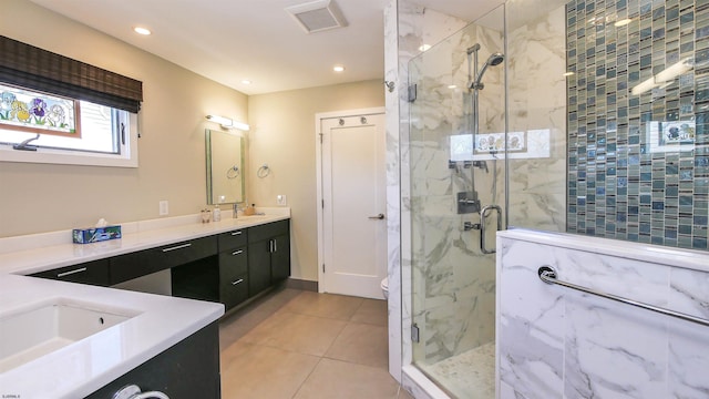 bathroom featuring toilet, vanity, tile patterned flooring, and a shower with door