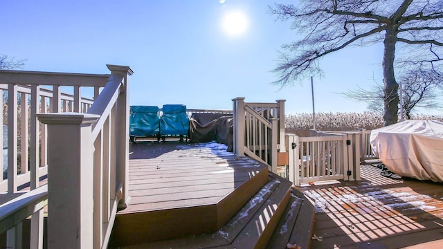 wooden terrace featuring a grill