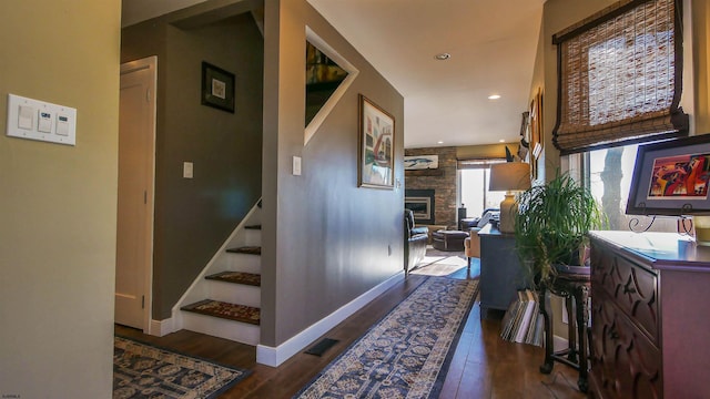 corridor with dark hardwood / wood-style flooring