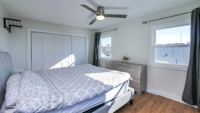 bedroom with a closet, ceiling fan, and dark hardwood / wood-style floors