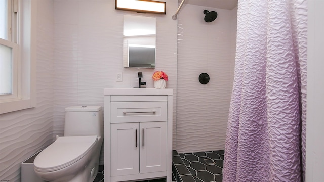 bathroom featuring toilet, walk in shower, and sink