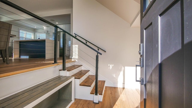 stairs featuring hardwood / wood-style floors